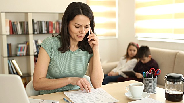 mother working from home with two children